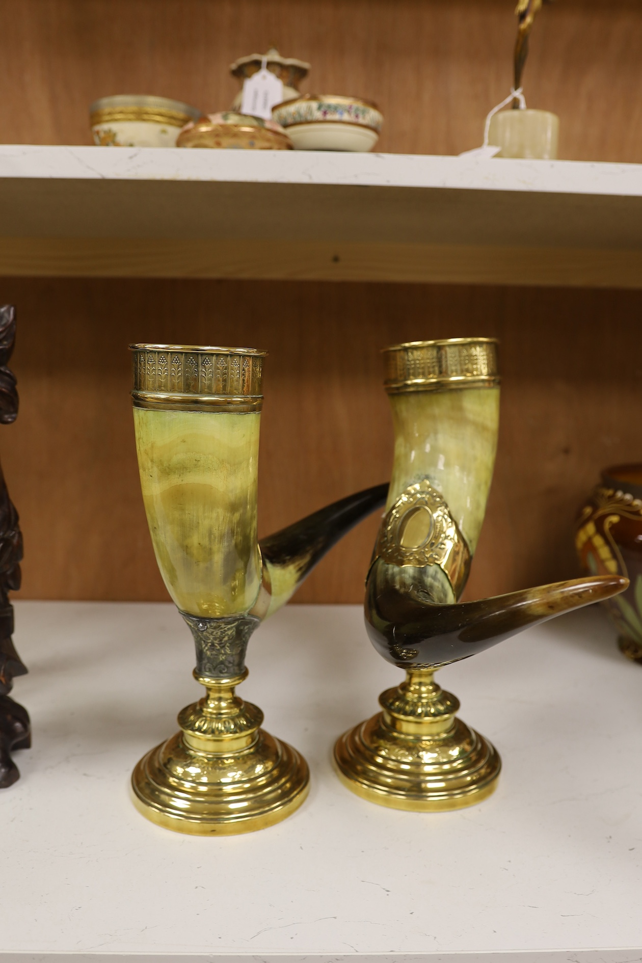 A pair of large decorative brass mounted horns, 33cm high. Condition - brass mounts dented and horns scratched in places